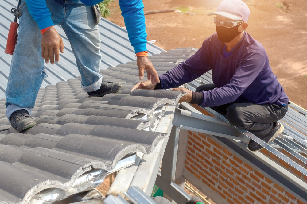 Roof,Repair,,Worker,Replacing,Gray,Tiles,Or,Shingles,On,House