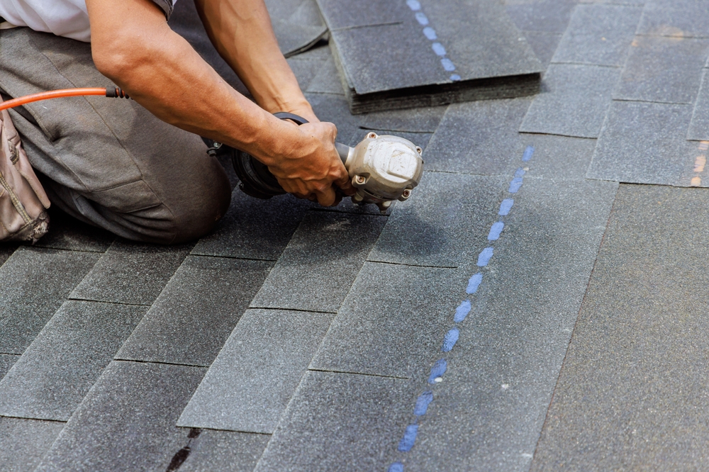 New,Asphalt,Bitumen,Shingles,Are,Being,Installed,By,Roofer,Using